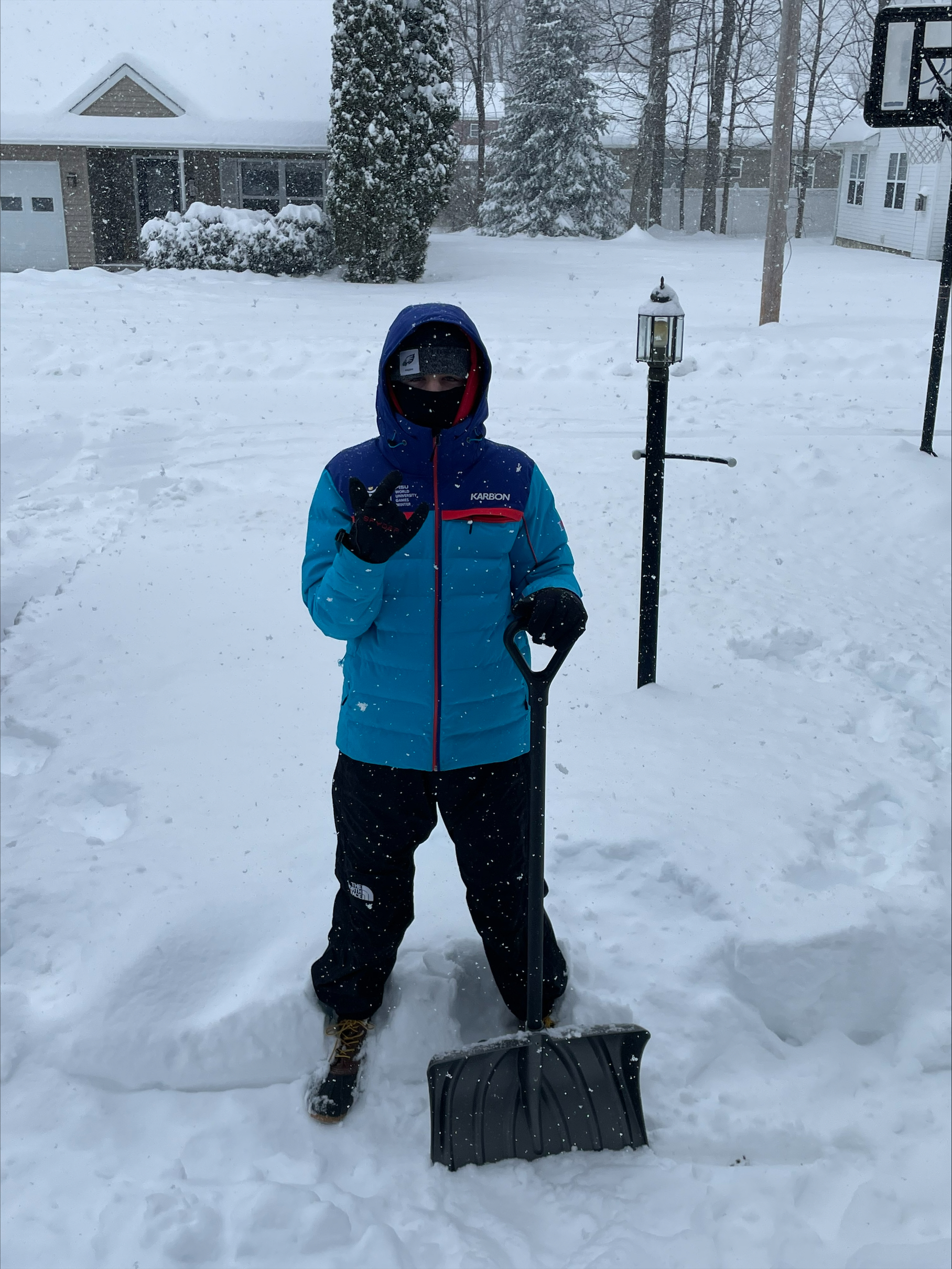 Cooper shoveling snow in the neighborhood Glens Falls, 13 in snow report_133pm