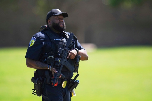 Police respond to reports of a shooting at Wilmer-Hutchins High School, in Dallas, Tx., Tuesday, April 15, 2025. (AP Photo/Julio Cortez)