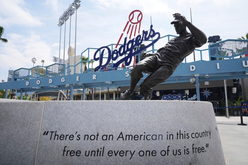 A statue of Jackie Robinson is seen at Dodger Stadium on Jackie Robinson Day before a baseball game between the Los Angeles Dodgers and Colorado Rockies Tuesday, April 15, 2025, in Los Angeles. (AP Photo/Damian Dovarganes)