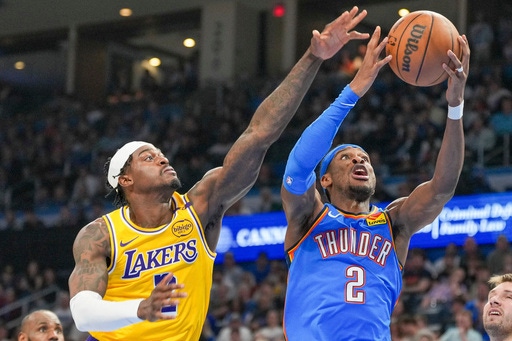 Oklahoma City Thunder guard Shai Gilgeous-Alexander, right, shoots near Los Angeles Lakers forward Jarred Vanderbilt, left, during the second half of an NBA basketball game, Tuesday, April 8, 2025, in Oklahoma City. (AP Photo/Kyle Phillips)