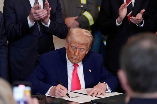 President Donald Trump signs an executive order during an event in the East Room of the White House, Tuesday, April 8, 2025, in Washington. (AP Photo/Alex Brandon)