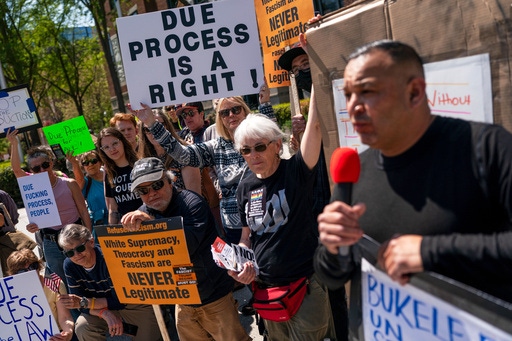Protestors chant during a demonstration against President Donald Trump's use of El Salvador's Terrorism Confinement Center, or CECOT, prison for people deported from the U.S. for entering the country illegally, outside the Embassy of El Salvador in Washington, Monday, April 14, 2025. (AP Photo/Nathan Howard)