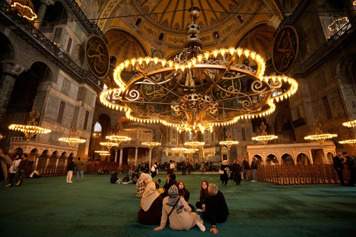 People visit Byzantine-era Hagia Sophia mosque in Istanbul, Turkey, Sunday, April 13, 2025. (AP Photo/Emrah Gurel)